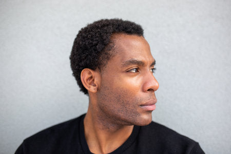 files/255785136-close-up-side-profile-of-a-man-looking-to-the-right-against-a-grey-wall.jpg